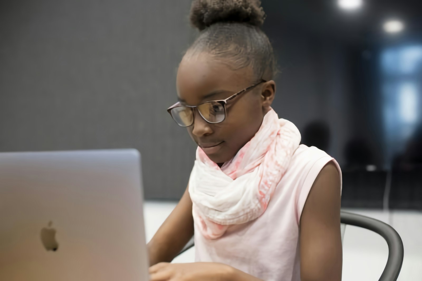A young student working on a laptop at school